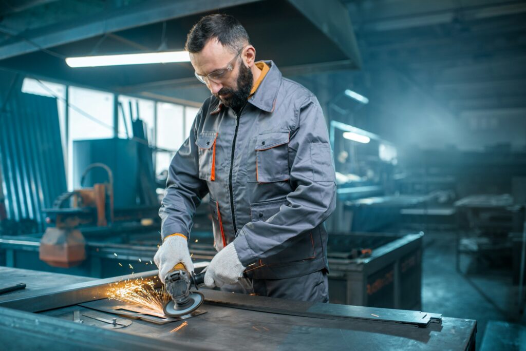 Metal industry worker at factory in work wear